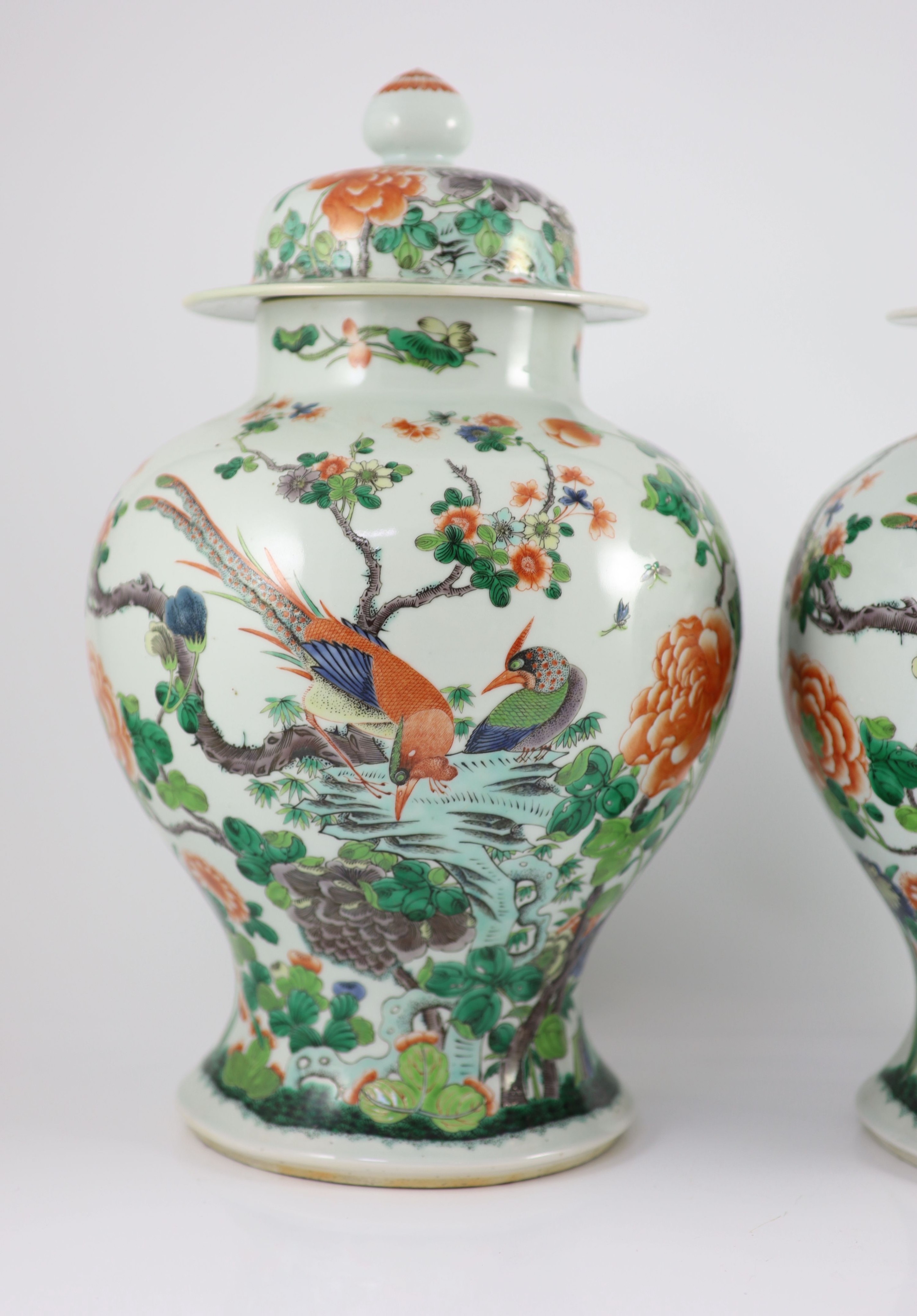 A pair of large Chinese famille verte jars and covers, late 19th century, 45cm high, restorations